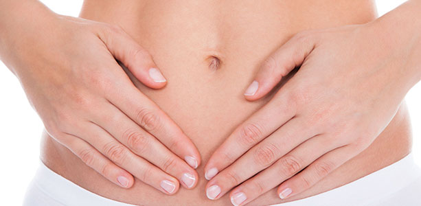 Woman's hands holding her stomach
