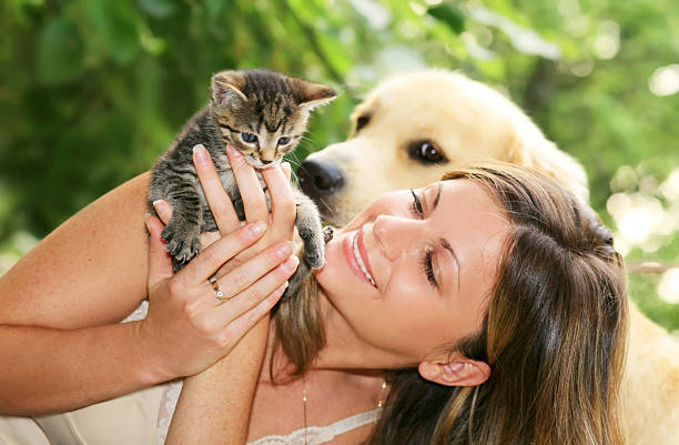 Woman with cat & dog outside in nature