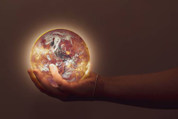 Hand holding world globe. Elements of this image furnished by NASA